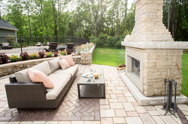Outdoor couch next to a warm Belvedere Fireplace