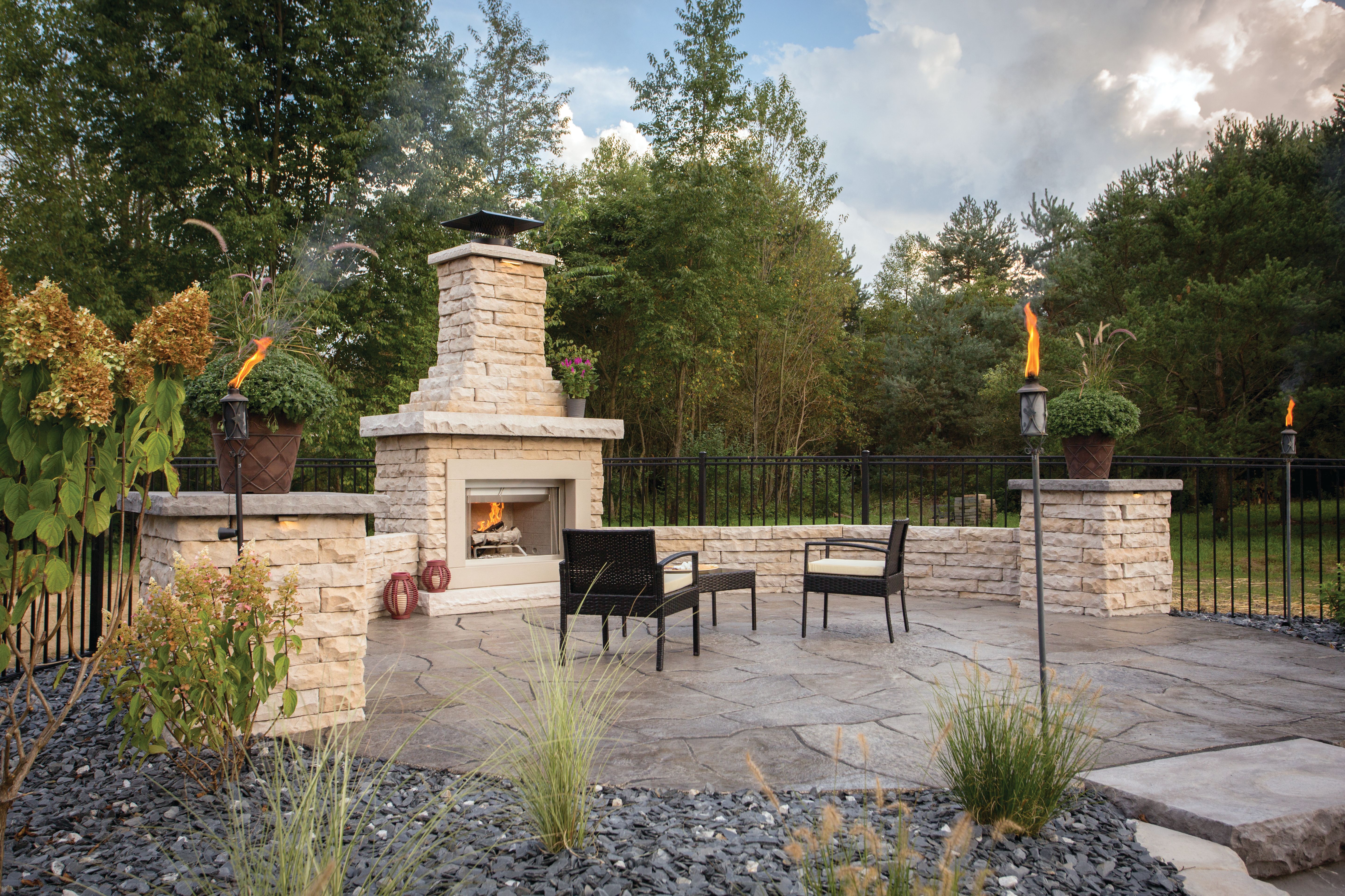 Claremont Fireplace on a Grand Flagstone Patio with Claremont columns and seat walls