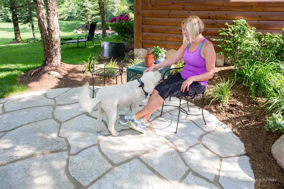 Grand Flagstone patio with dog and owner
