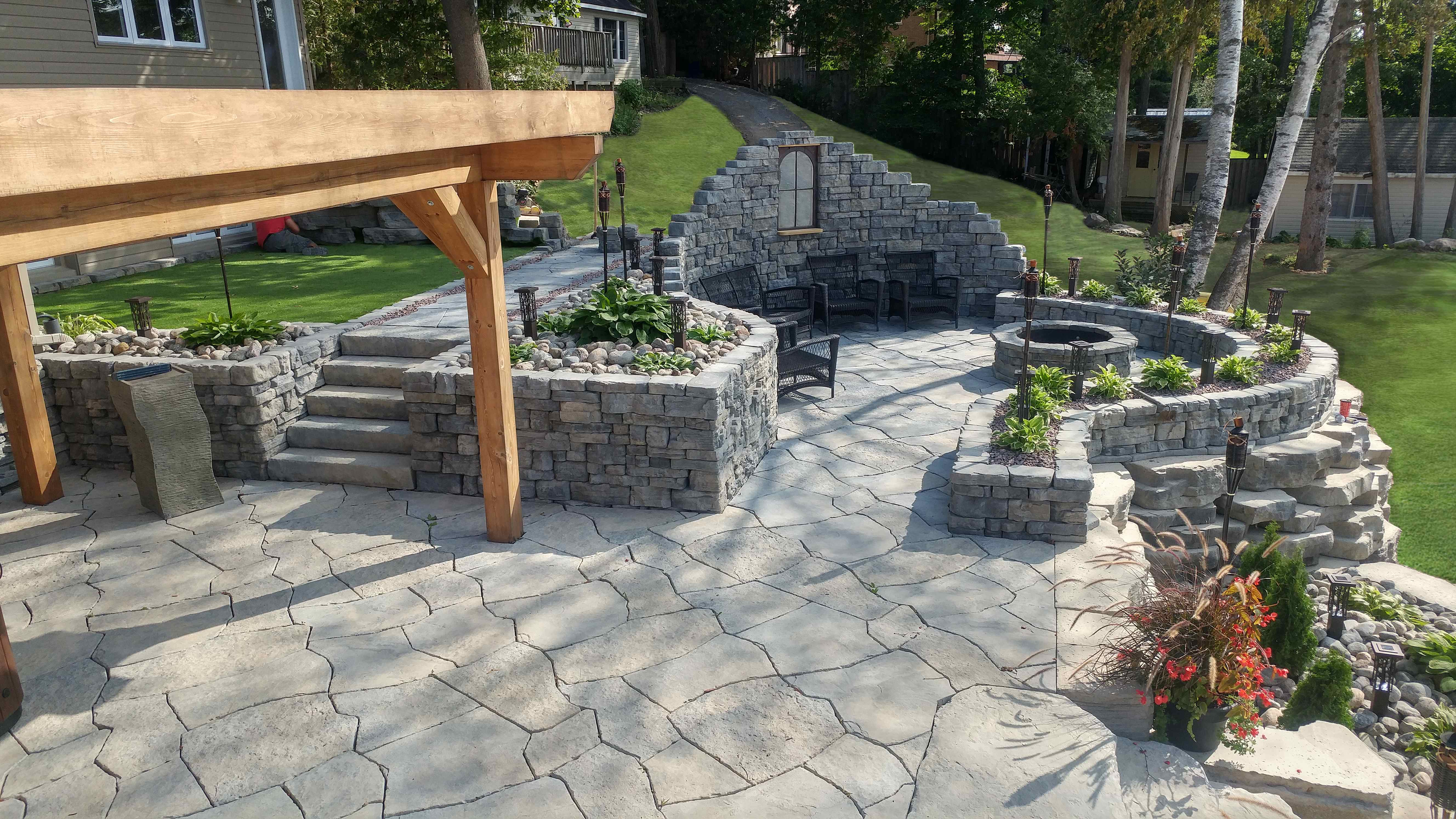 Residential Grand Flagstone patio with Belvedere walls and firepit area 