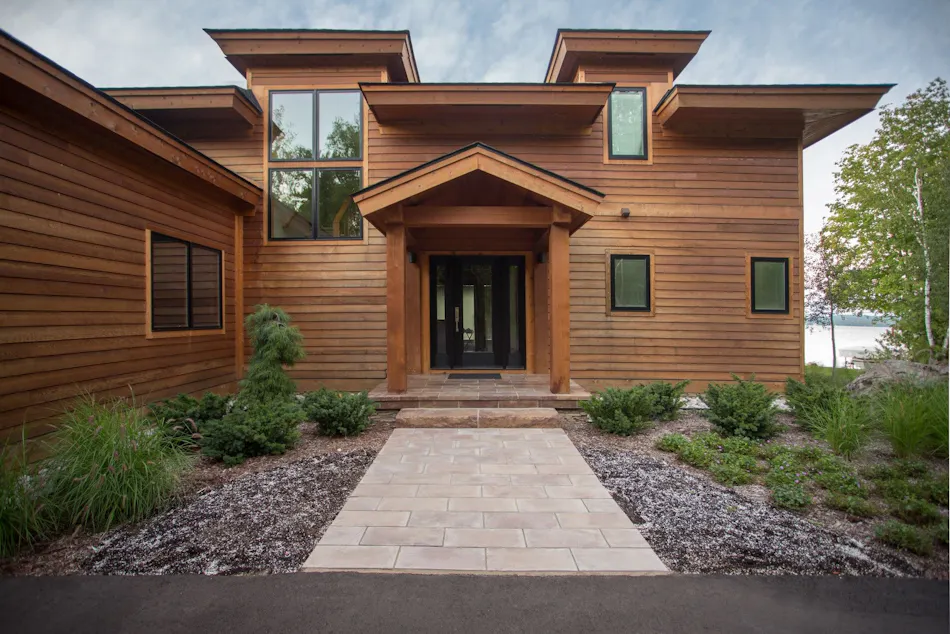 Linear flagstone walkway leads to a friendly front door
