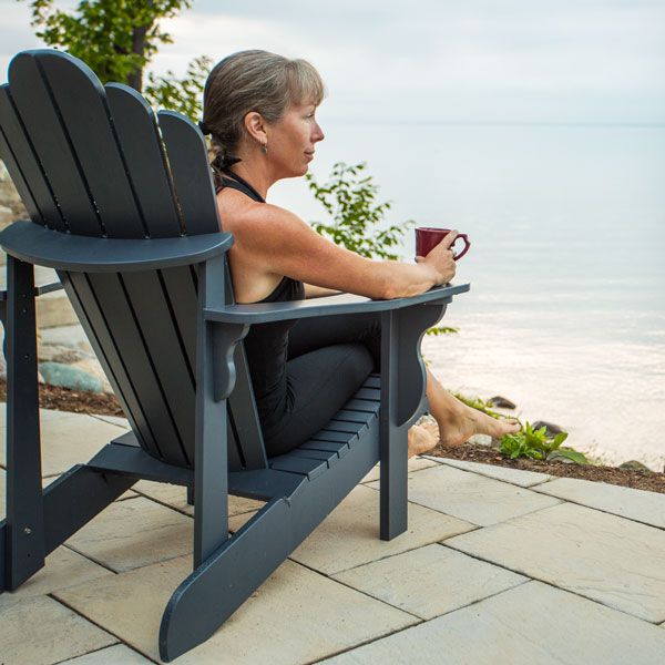 person in chair overlooking water