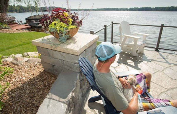 Man looking at lake next to Kodah wall and column with Grand Flagstone pavers