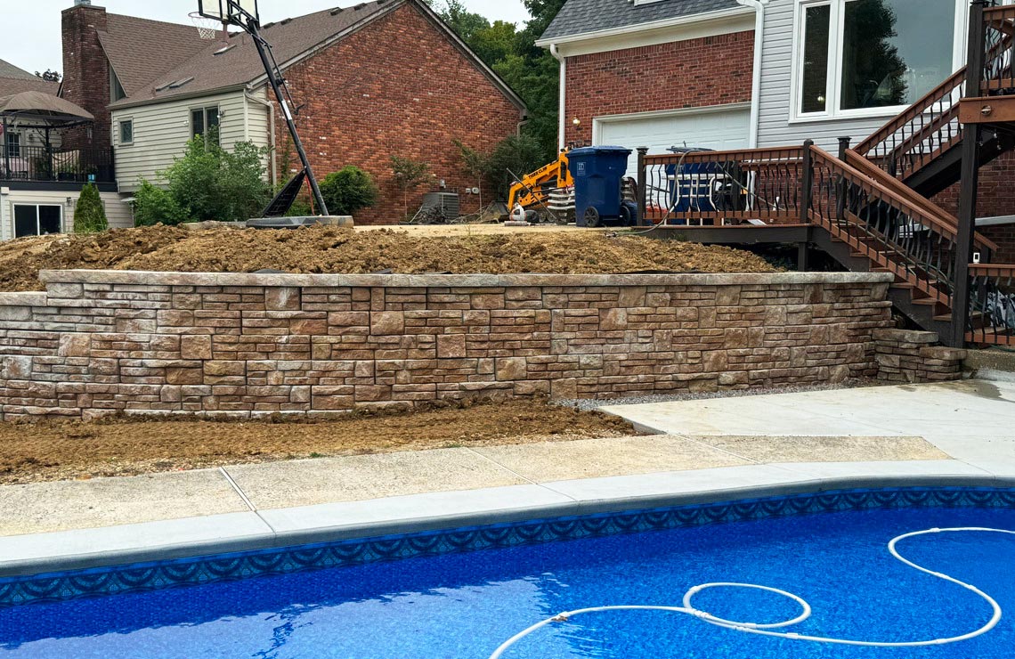 image of stained alpine textured novum wall in backyard pool area