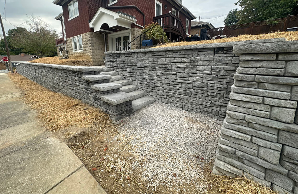 image of alpine textured Novum retaining wall and stairs in front of house