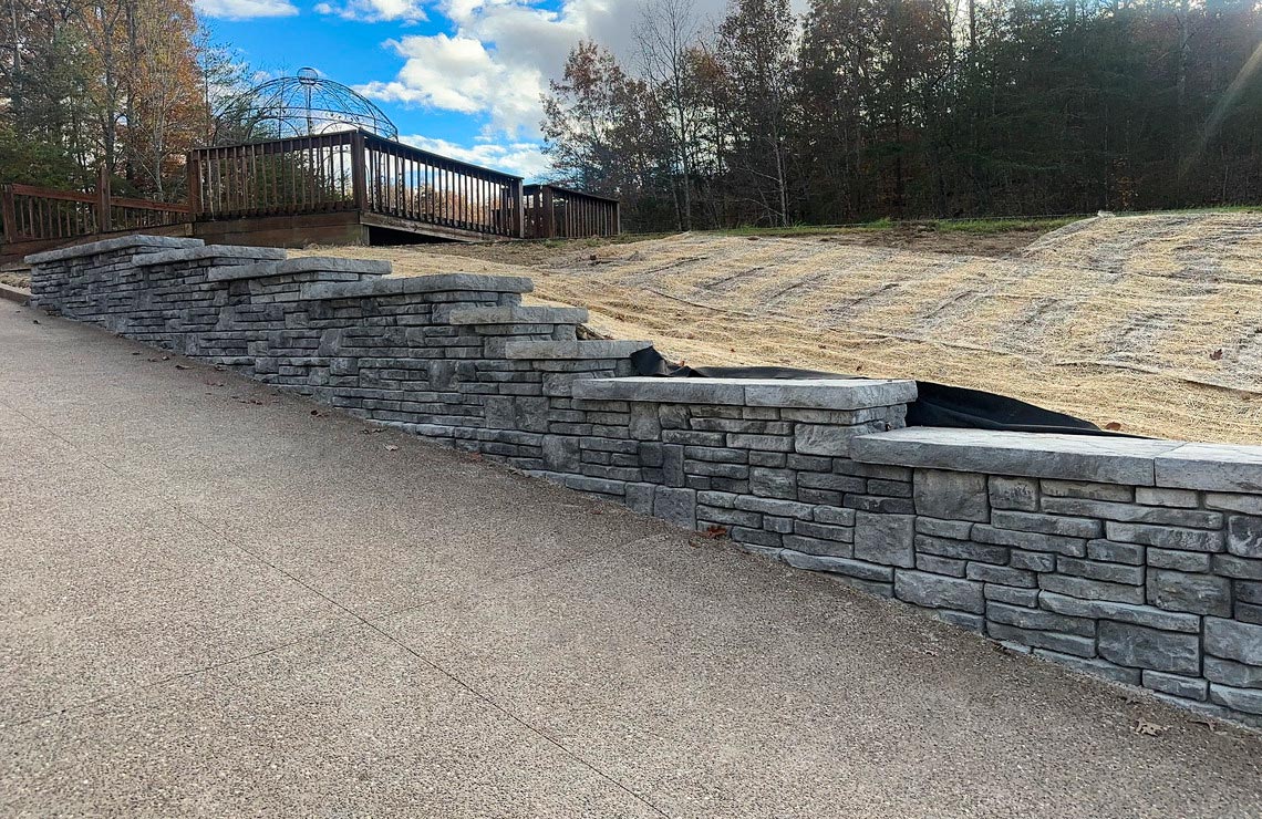 image of alpine textured novum wall for residential driveway with patio in background