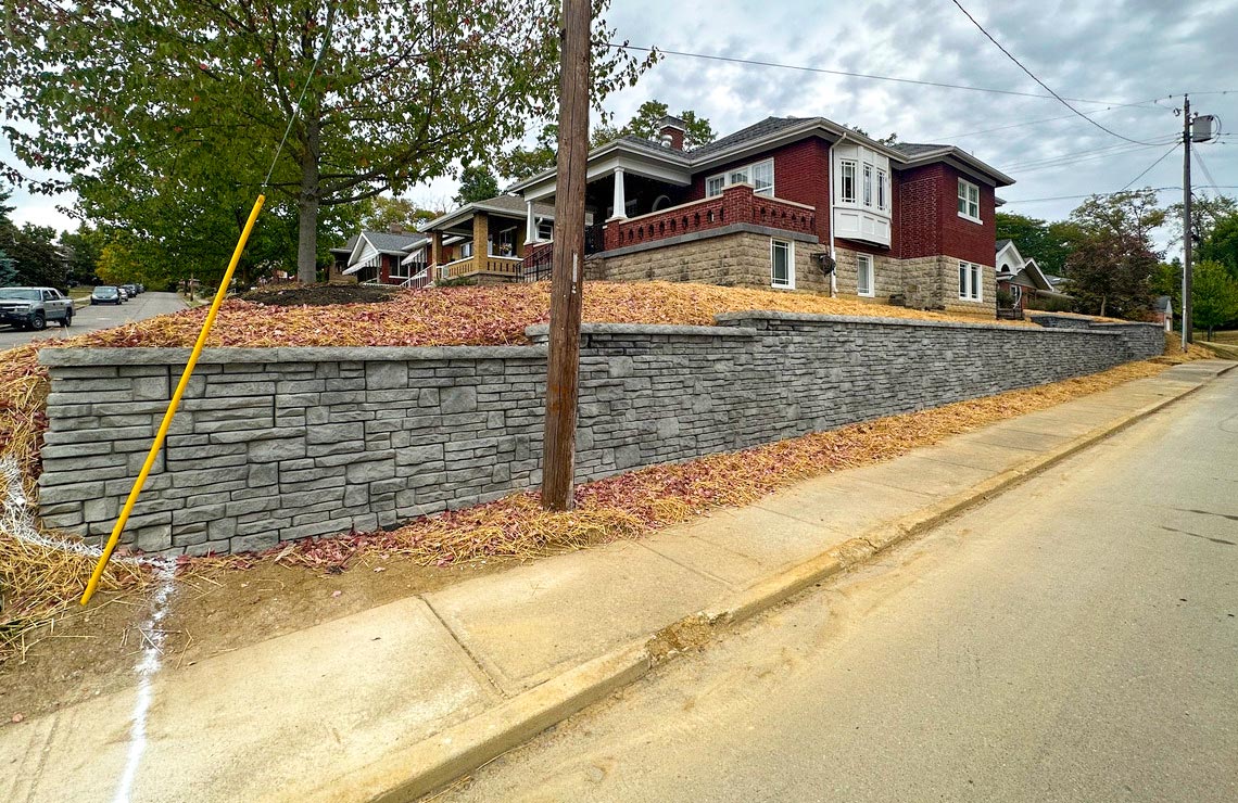 image of novum wall wall in front of house next to sidewalk