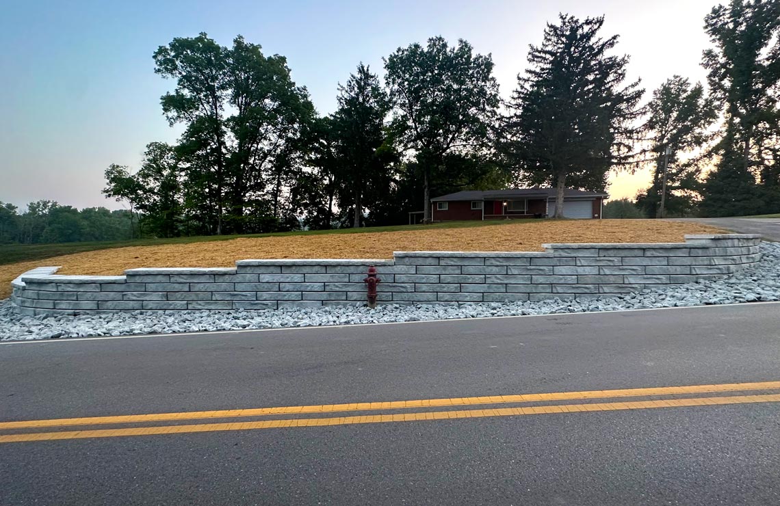 image of Summit texture novum wall wall with road in front of wall and house in background