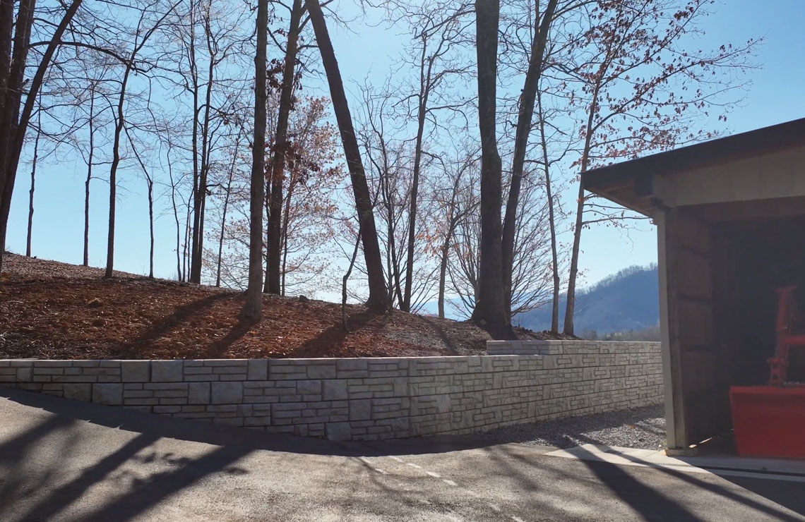 image of alpine novum wall with trees in background and garage on the right