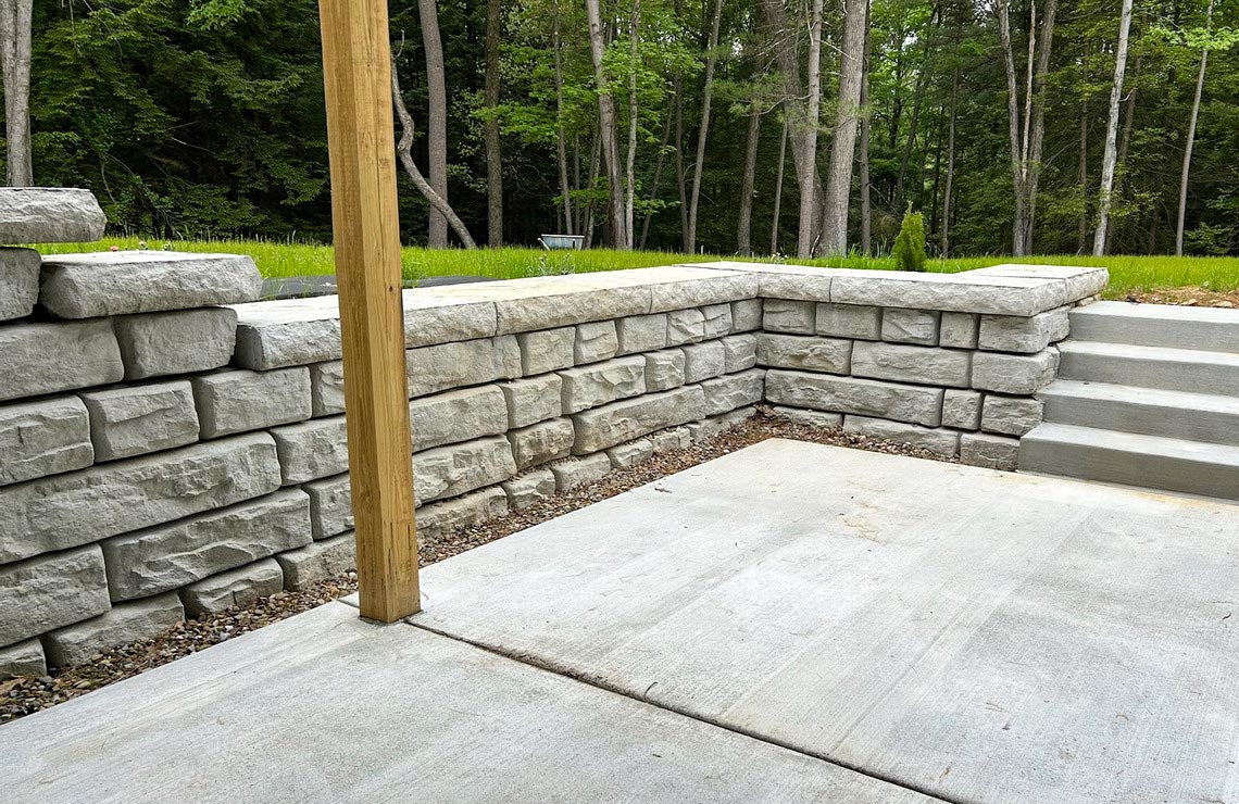 image of backyard patio area with novum wall Ridge textured wall with stairs leading to yard