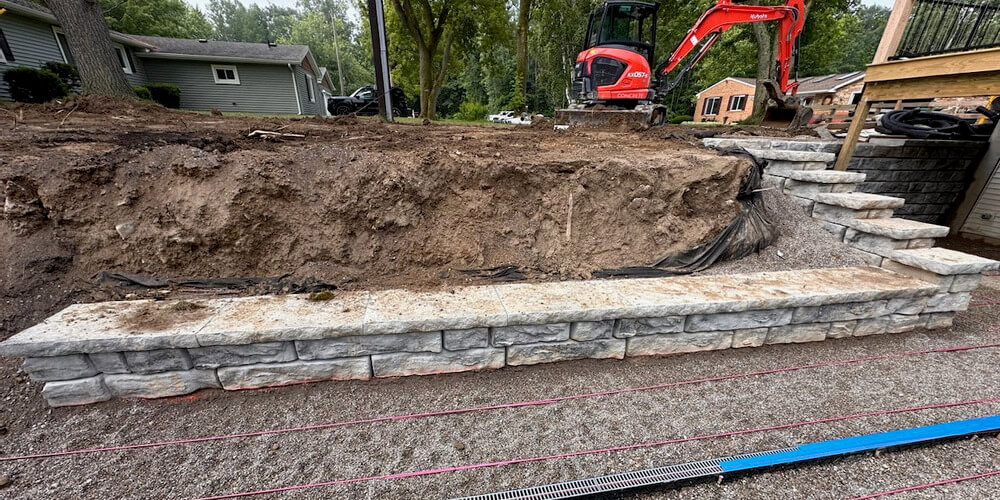 image of novum wall blocks being installed with excavator