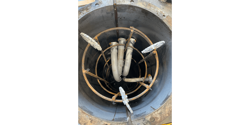 An internal view of a Pole Base form with conduit and rebar prepared for pouring. 