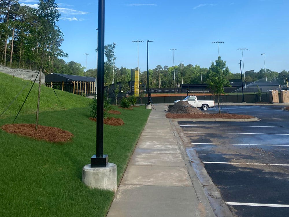 image of light pole base in front of sports complex