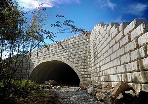 Limestone retaining walls create bridge for water culvert 