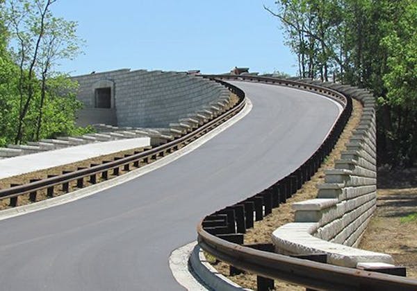 Limestone retaining walls create roadway ramp