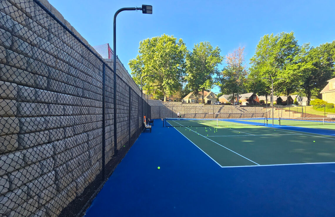image of tennis court with redi-rock XL wall surrounding court