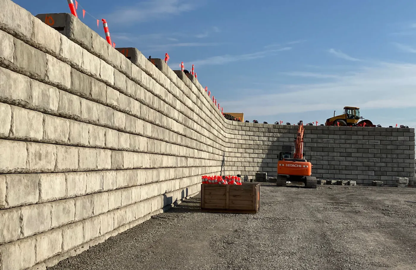 image of limestone redi-rock wall being installed with excavators