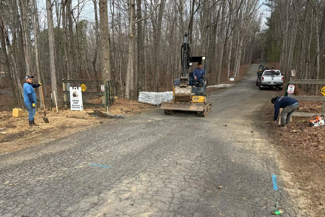 A tired cattle gate creates an unwelcoming entry at a Redi-Rock project.