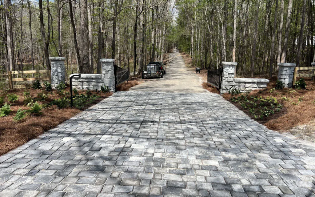 A Redi-Rock freestanding wall and column entryway project with complimentary paver driveway.