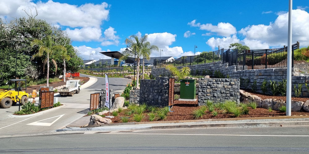 image of redi-rock ledgestone wall on corner of entrance to building just off of road