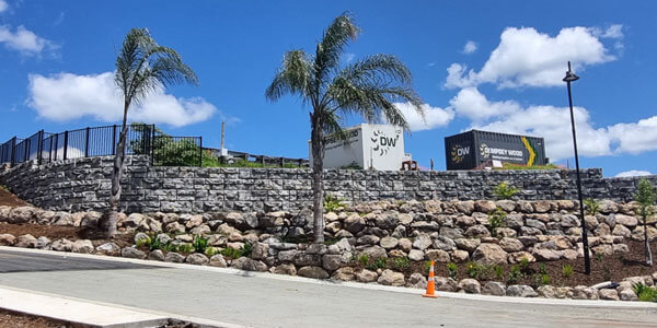 image of redi-rock ledgestone wall on corner of entrance to building just off of road