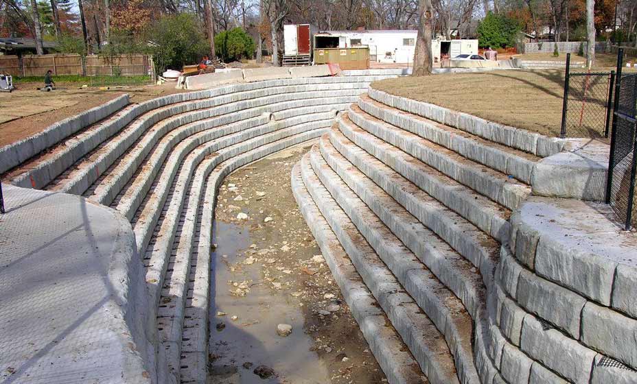 Curved Limestone retaining walls used to support channel and slow the flow of water