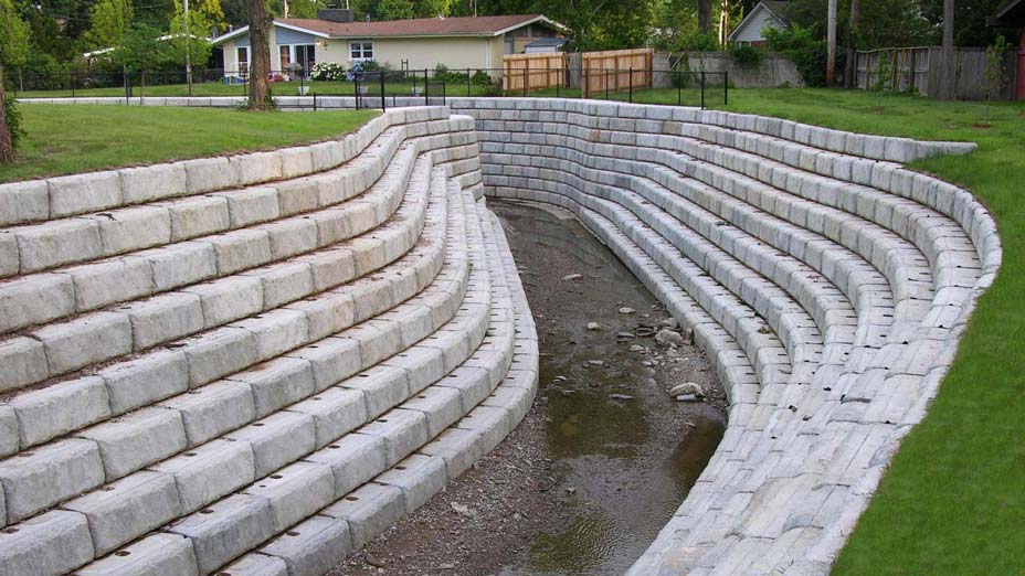 Curved channel support created with Limestone retaining wall blocks