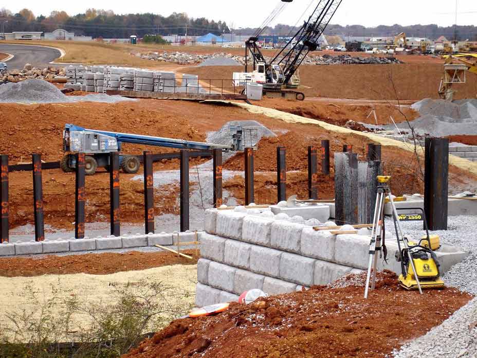 Installation of Redi-Rock retaining wall blocks for bridge