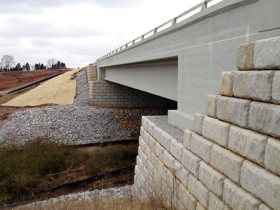 Limestone retaining wall abutments support bridge