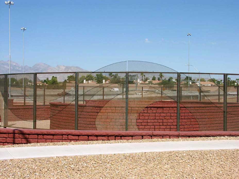 Curved Cobblestone wall with red coloring to match Las Vegas landscape