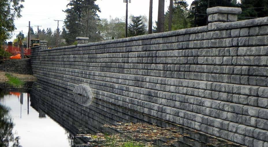 Completed Cobblestone wall supporting roadway spanning across lake