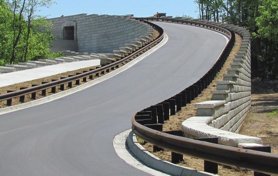 Limestone retaining walls create roadway ramp