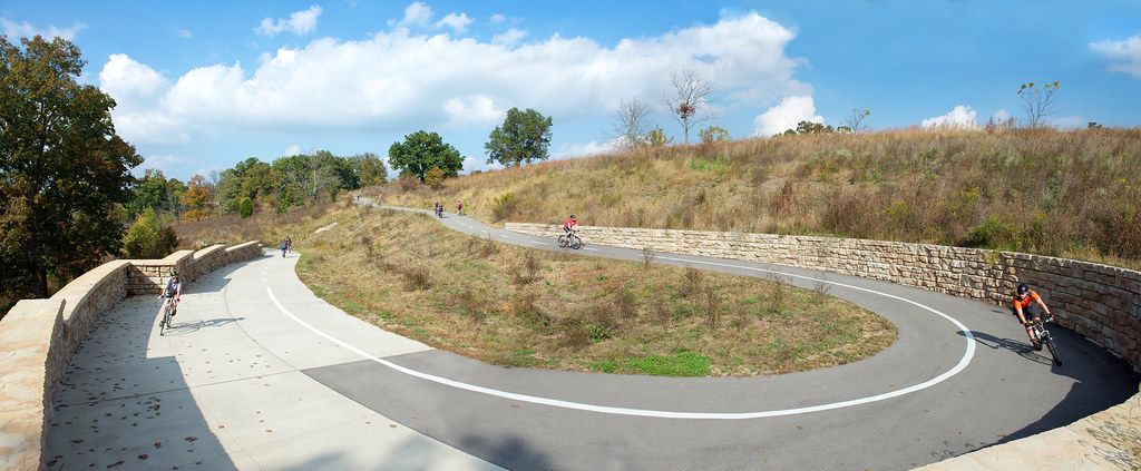 Curved Ledgestone retaining wall provides structure to bike path