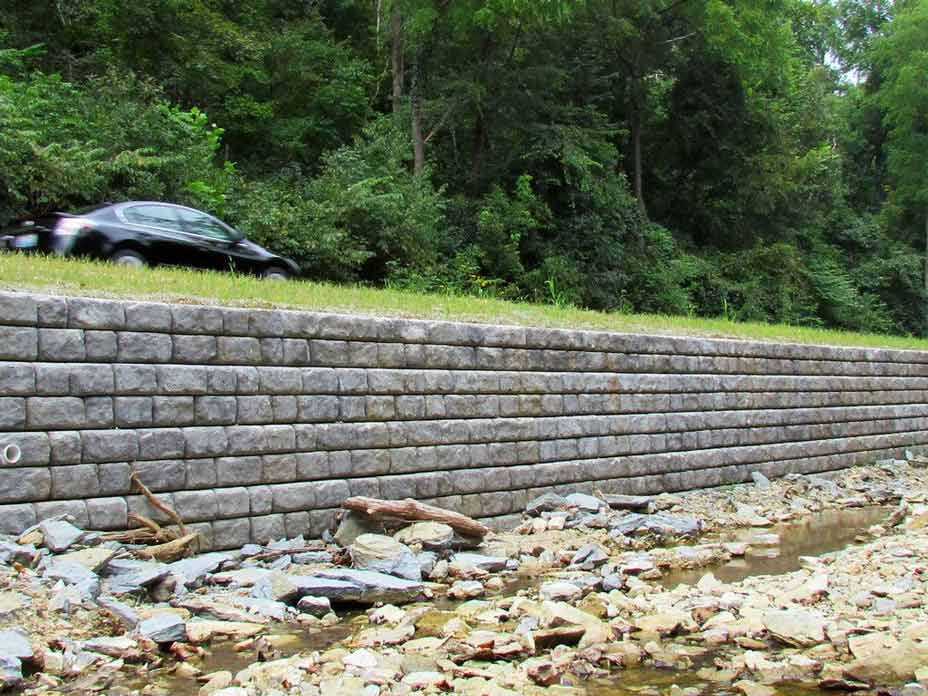 Cobblestone retaining wall supporting roadway