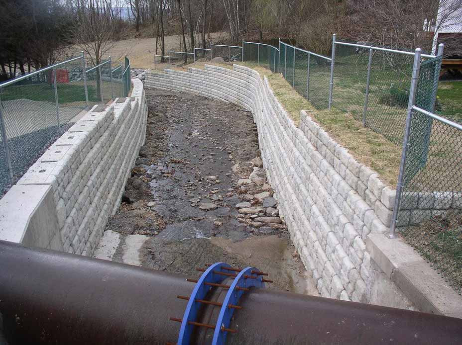 Newly restored Coal Creek storm channel with Cobblestone retaining walls