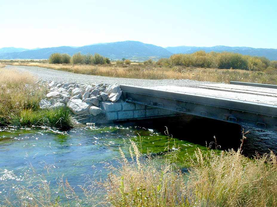 Recycled rail car used as bridge over stream