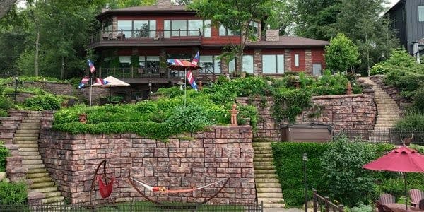 image of redi-rock walls covered in plants in backyard of lakehouse