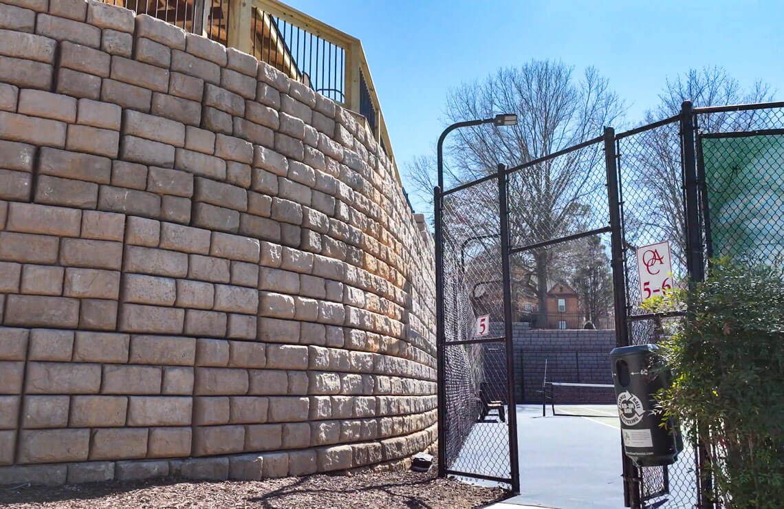image of redi-rock XL wall next to tennis court entrance