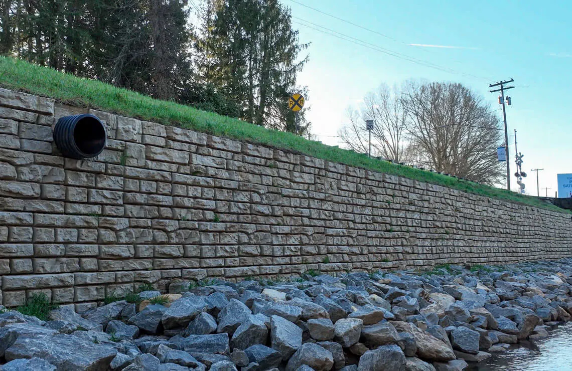 drone image of redi-rock ledgestone wall along river