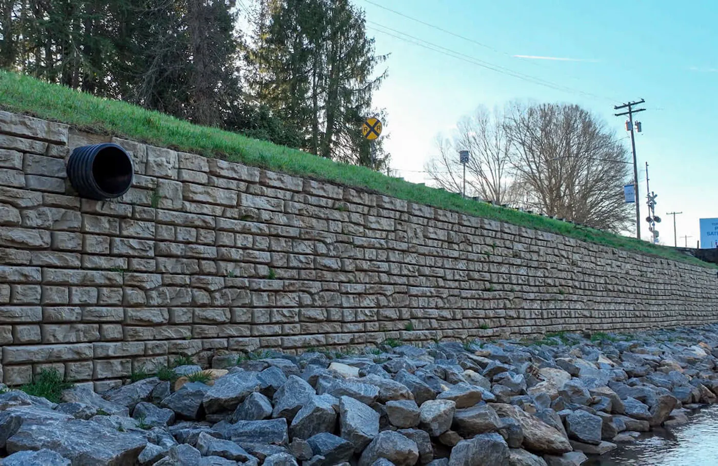 drone image of redi-rock ledgestone wall along river