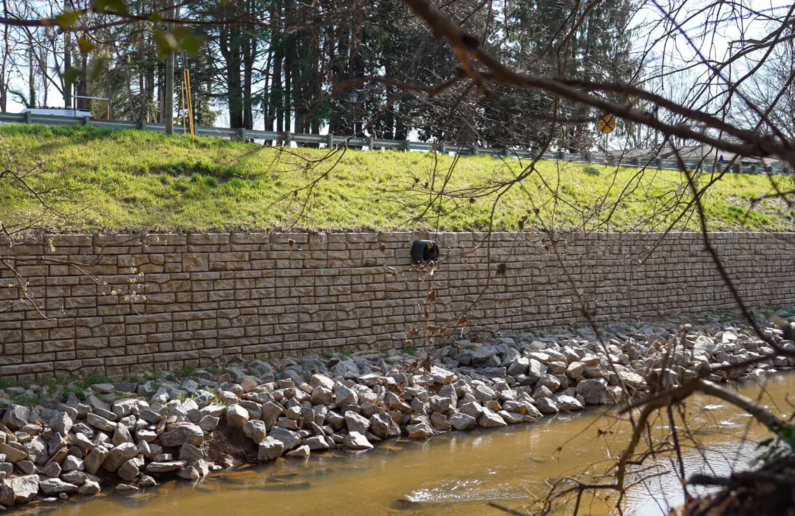 drone image of redi-rock ledgestone wall along river