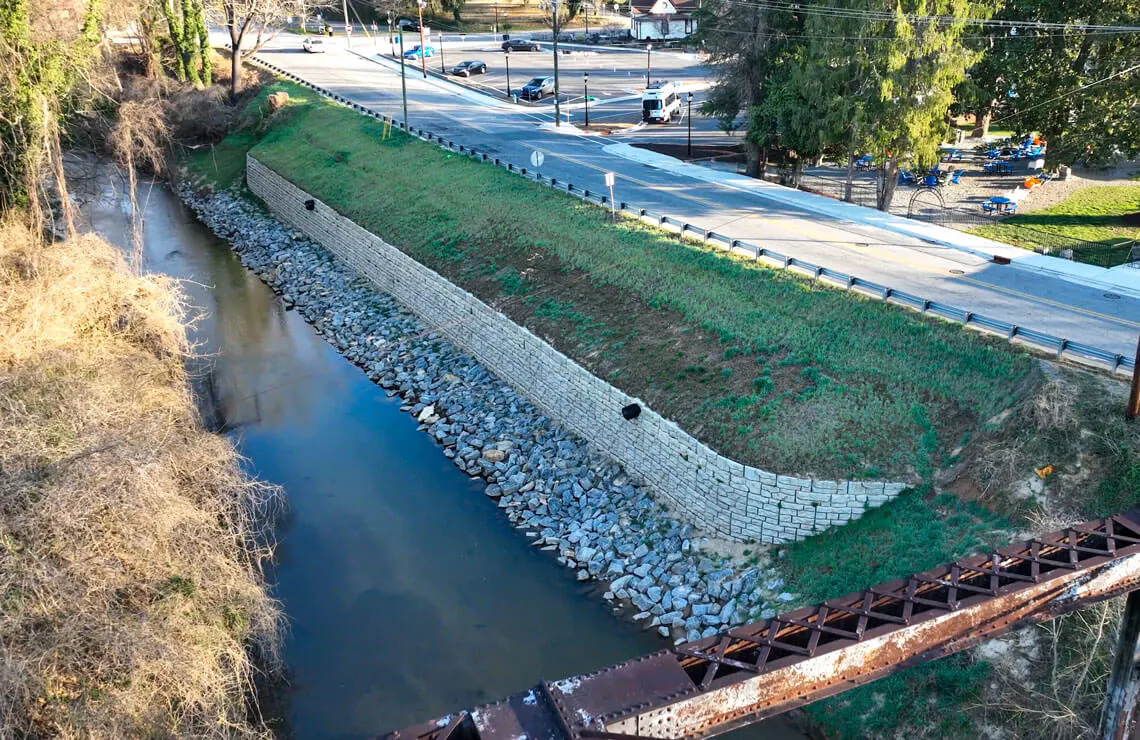 drone image of redi-rock ledgestone wall along river