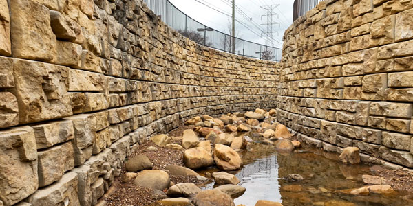 image of stormwater channel with redi-rock ledgestone walls on both sides