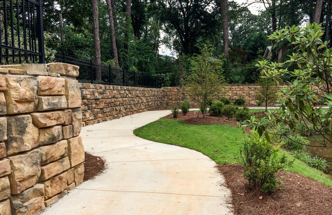 image of sidewalk lined with redi-rock walls