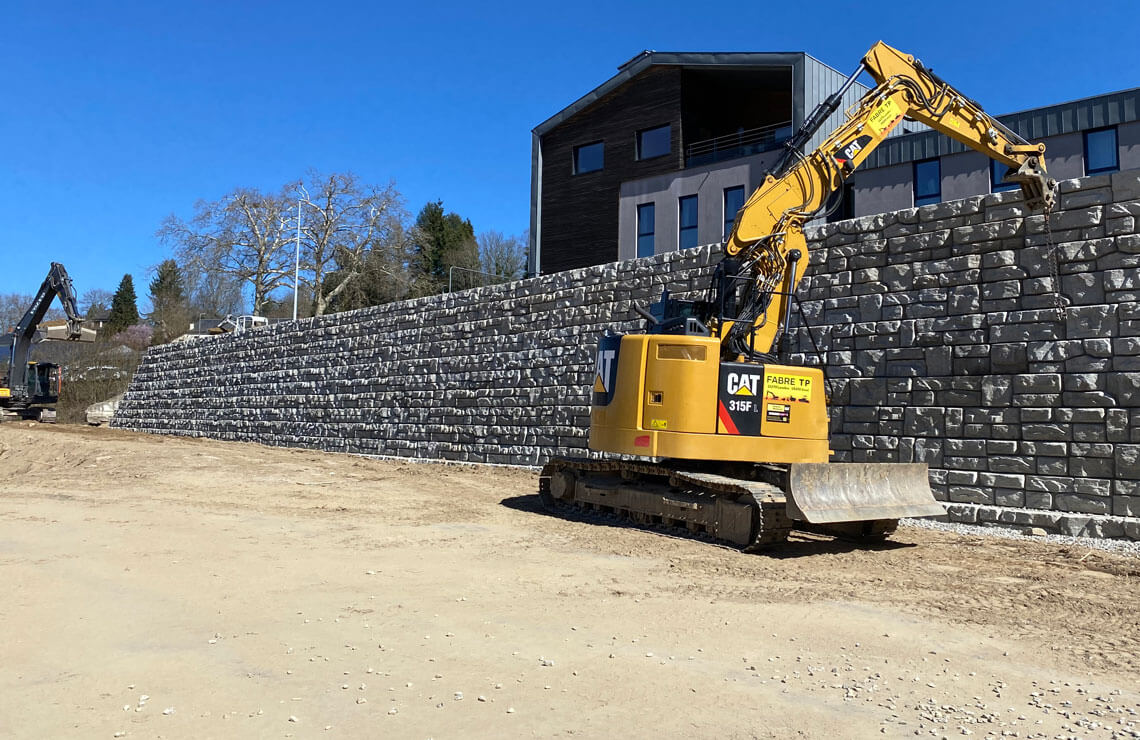 image of crane installing redi-rock blocks for wall for building