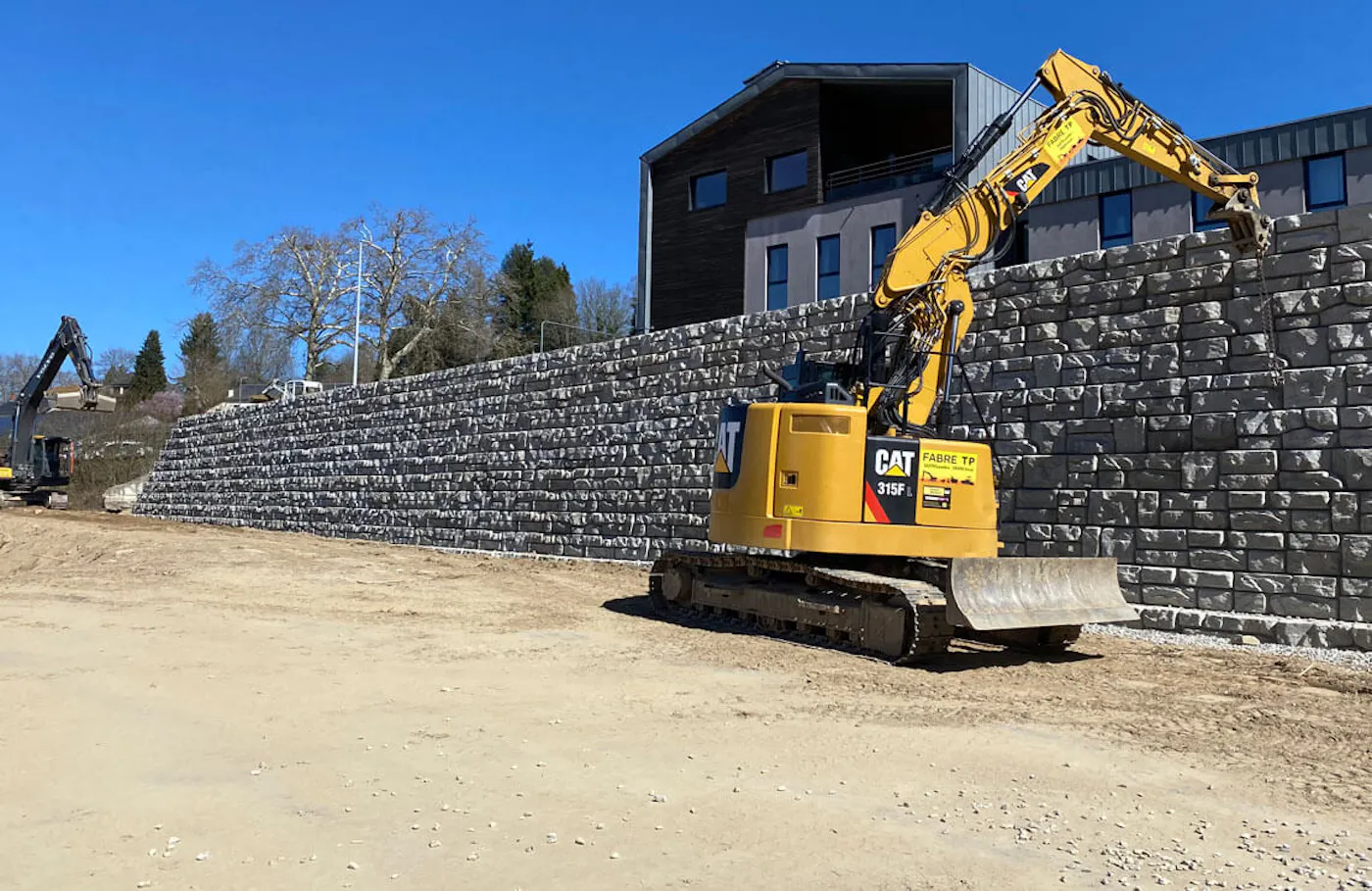 image of crane installing redi-rock blocks for wall for building