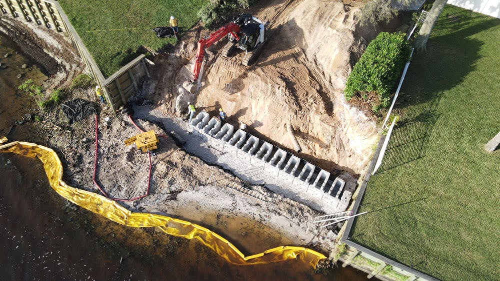aerial image of image of redi-rock wall install with dewatering