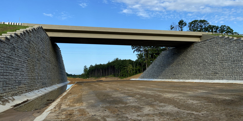 image of tall redi-rock retaining walls with bridge on top