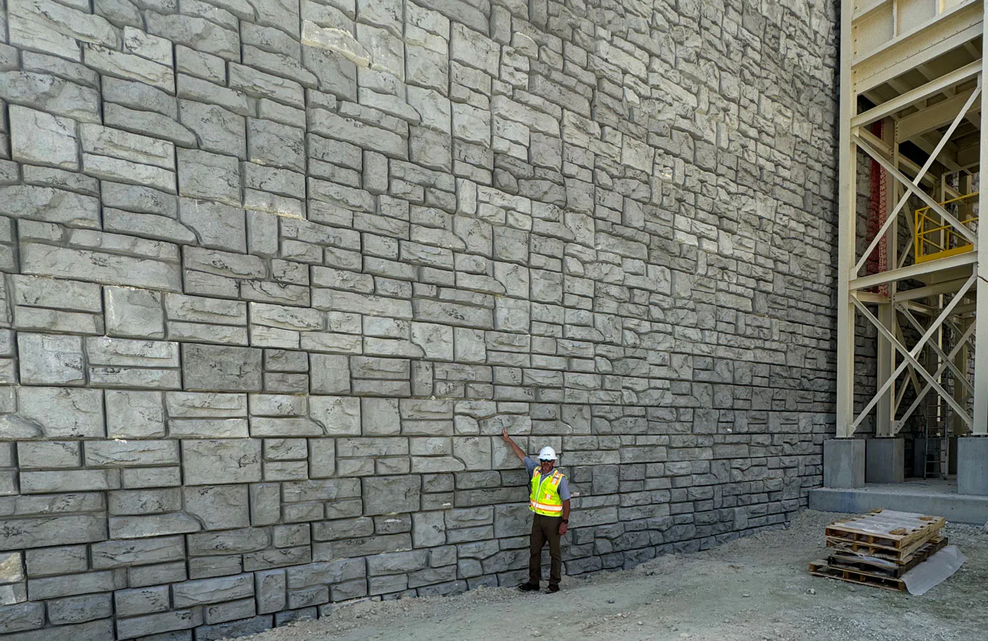 image of person standing in front of redi-rock wall