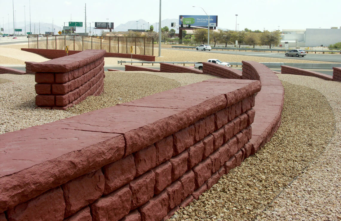 image of stained redi-rock freestanding walls next to highway